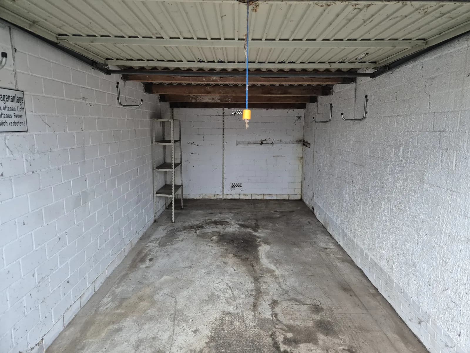 Empty garage after the clearout with bare concrete floor and clean walls