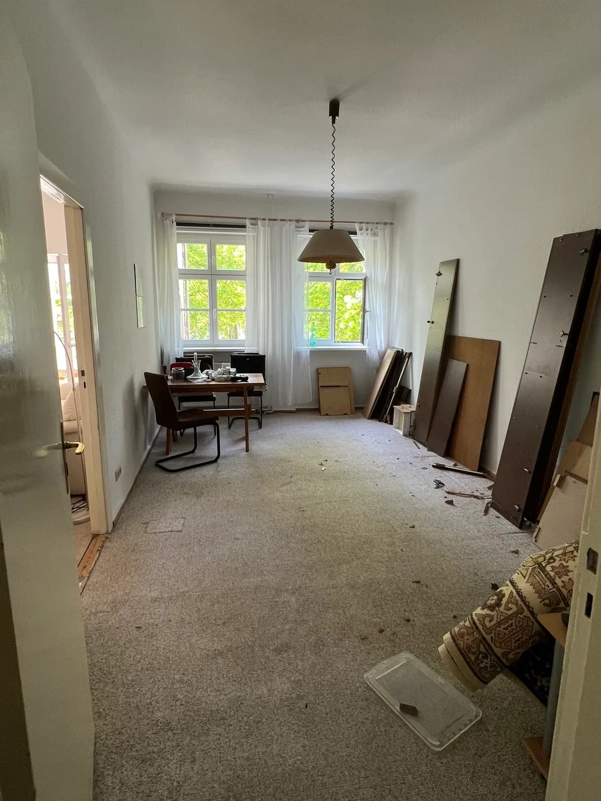 Room with a desk and furniture parts leaned against the wall during a move in Berlin