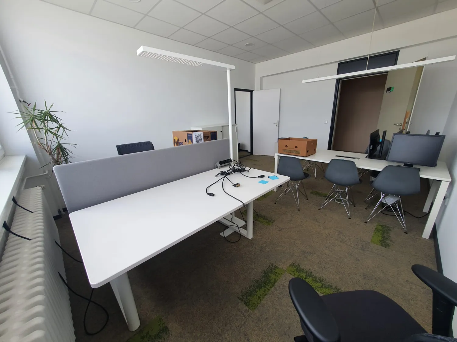 Office in Berlin with a desk and stacked moving boxes during a relocation