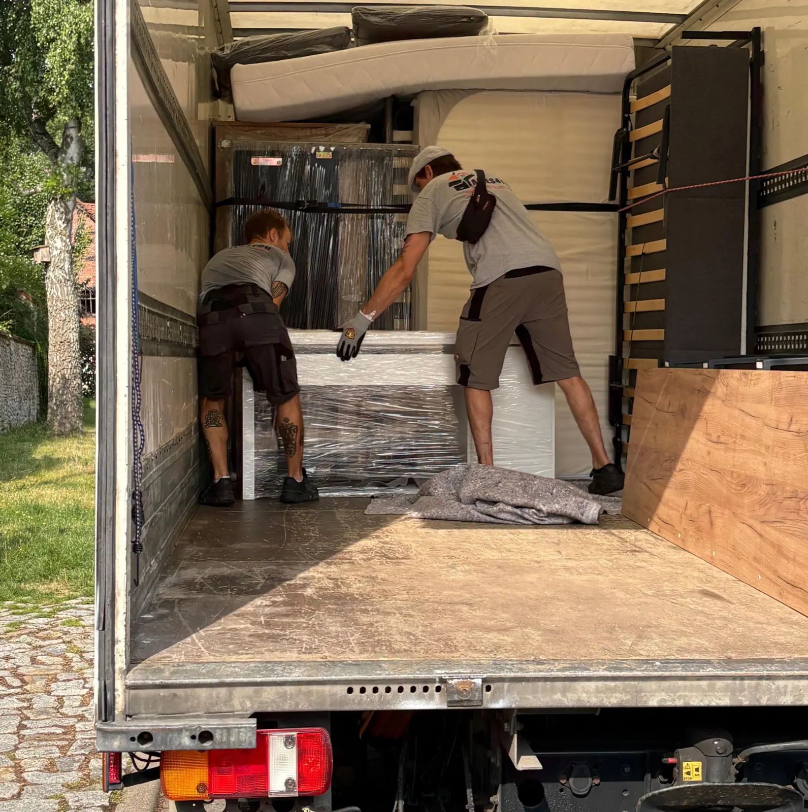Alles4You staff carrying furniture from a flat clearance to the van